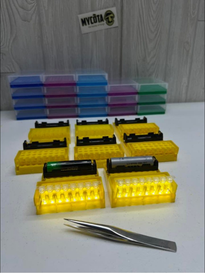 Several lit extraction units on a bench with tweezers in front