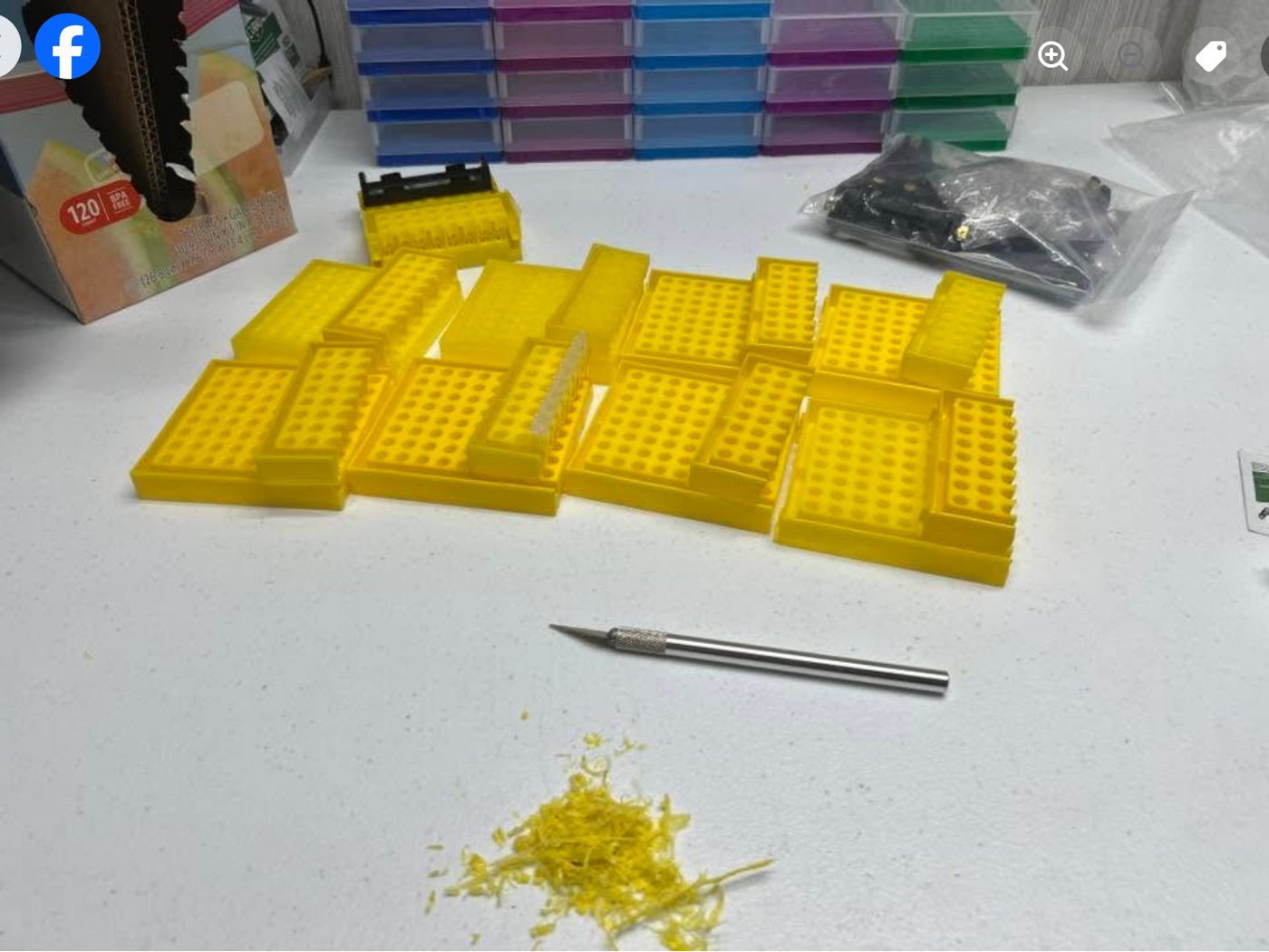 Cut rack sections, a hobby knife and yellow plastic shavings