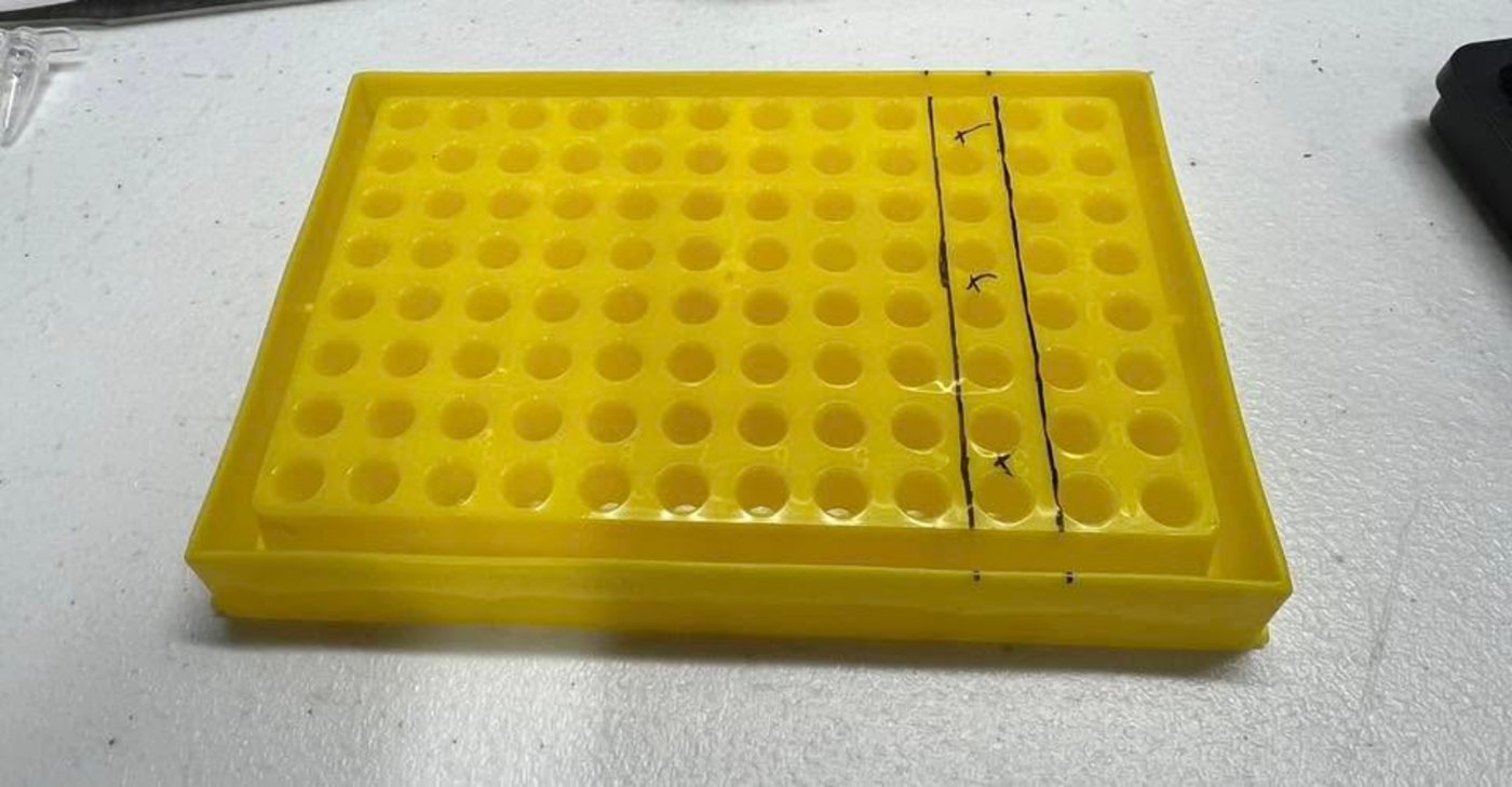 A yellow 96-well rack with cut lines marked across it