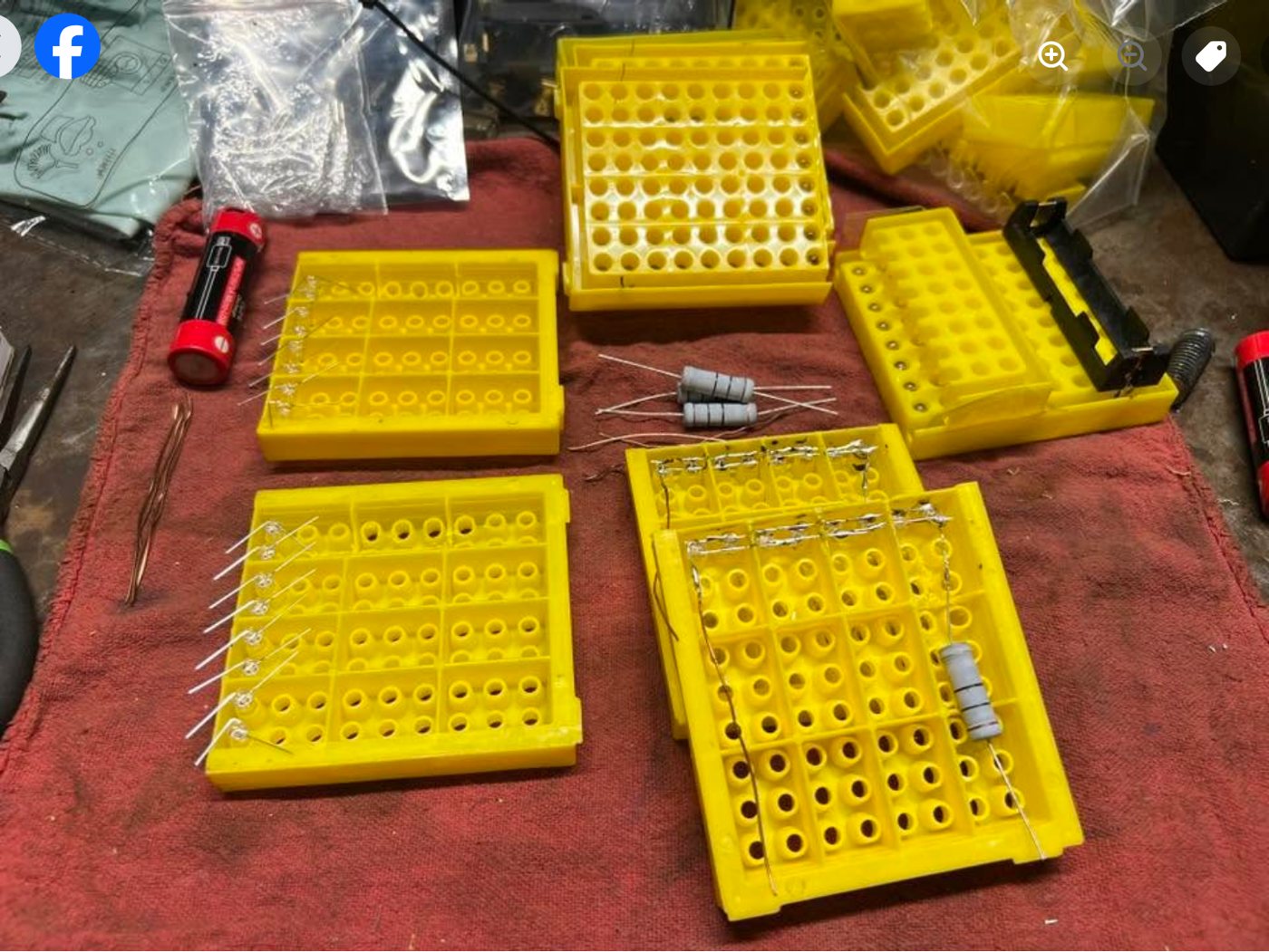 Yellow rack sections with LEDs and resistors being fitted